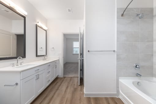 a bathroom with two sinks and a tub and a shower at Birdie on Woodland Greens, Austin, 78726