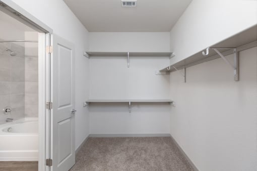 a spacious bathroom with a shower and a door to a closet at Birdie on Woodland Greens, Texas