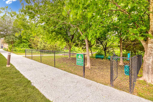 a park with a chain link fence and a sign for a dog park at Radius on Grove, Austin, TX, 78741