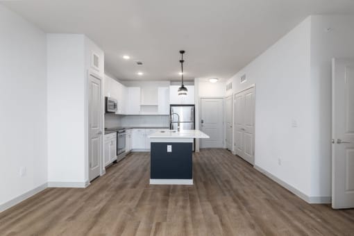 a renovated kitchen with white cabinets and a white counter top in a new home at Birdie on Woodland Greens, Austin