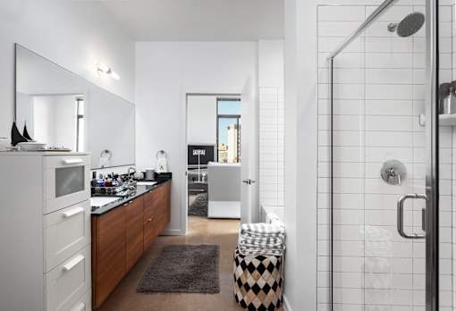Modern bathroom with walk-in shower at THE'68 Apartments, Texas
