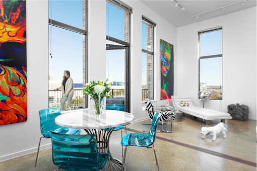 Modern living room with colorful art and balcony access at THE'68 Apartments, Texas, 78205