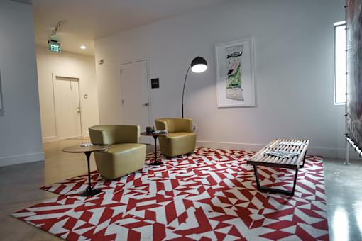 Lounge seating area with geometric patterned rug at THE'68 Apartments, San Antonio, Texas
