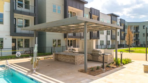 a large patio with a pool and a building at Birdie on Woodland Greens, Austin, Texas