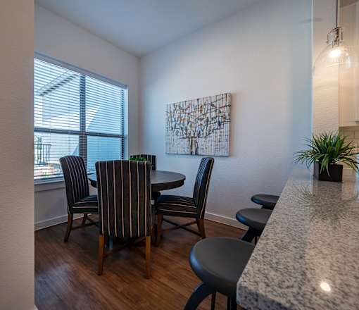 A dining room with a table set for four.