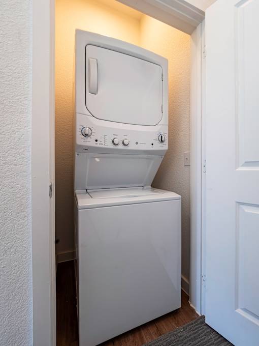 A white oven and dishwasher in a small room.