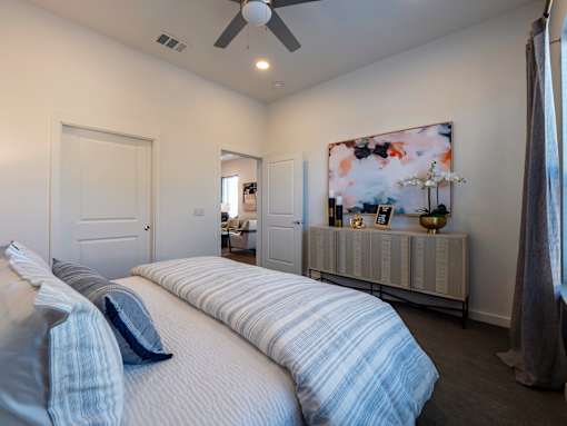 A bedroom with two beds and a ceiling fan.