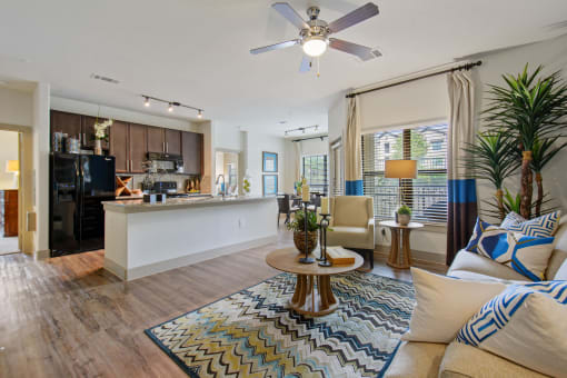 a living room and kitchen area with a ceiling fan at Alvista Round Rock, Round Rock, TX, 78664