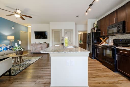 a kitchen and living room with wood floors and a ceiling fan at Alvista Round Rock, Round Rock, TX, 78664