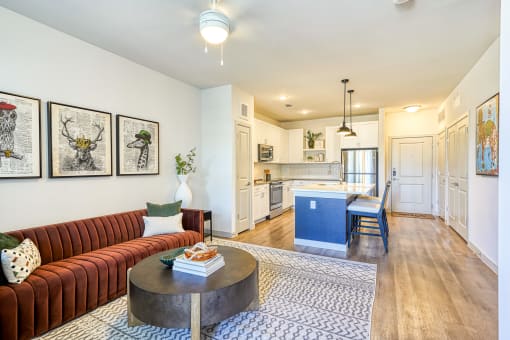 a living room with a couch and a table in front of a kitchen at Birdie on Woodland Greens, Texas