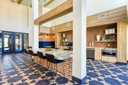 a large kitchen with a long table and chairs in a lobbyat Birdie on Woodland Greens, Austin