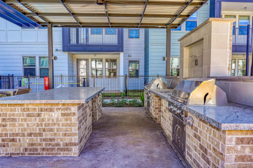 a kitchen area with two counters and a building at Birdie on Woodland Greens, Austin, 78726