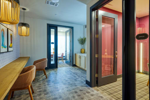 a dining room with a table and chairs and a door to a bathroom at Birdie on Woodland Greens, Austin