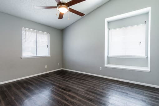 an empty living room with a ceiling fan and a window at Northchase,Texas