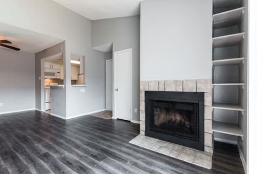 a living room with a fireplace and a book shelf at Northchase, Austin, TX, 78753