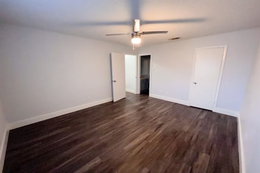 an empty living room with wood flooring and a ceiling fan at Northchase, Austin