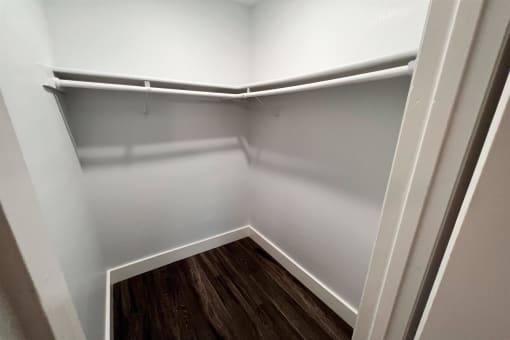 the preserve at ballantyne commons empty closet with wood floor and white walls at Northchase, Austin, TX