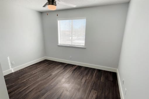 an empty room with wood flooring and a window at Northchase, Austin