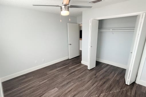 an empty bedroom with a closet and a ceiling fan at Northchase,Texas