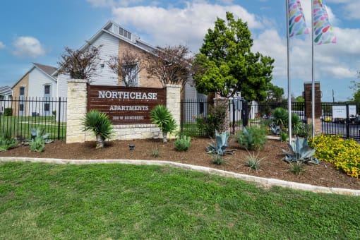 the entrance to northeast apartments sign in front of a fence at Northchase, Texas, 78753