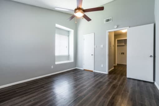 an empty living room with wood floors and a ceiling fan at Northchase, Texas, 78753