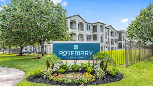 A sign for Rosemary Luxury Living in front of a building at Rosemary Apartments, Conroe, TX, 77384