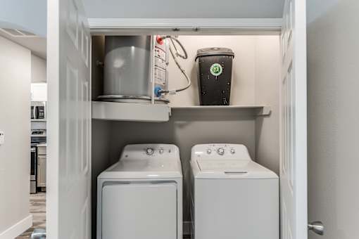 A laundry room with a washer and dryer in it at Rosemary Apartments, Conroe, TX
