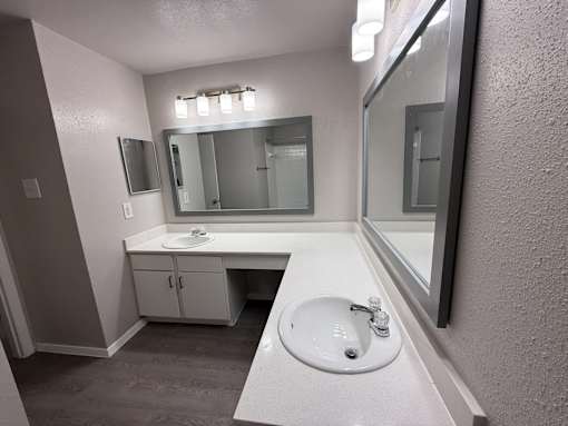 A bathroom with a sink and mirror.