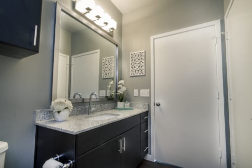 a bathroom with a sink and a mirror at Republic at Alamo Heights, San Antonio, 78209
