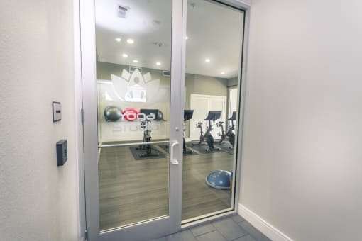 a view of the fitness center from the entrance of the building at Republic at Alamo Heights, San Antonio Texas