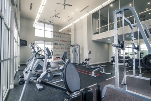 a gym with weights and other exercise equipment at Republic at Alamo Heights, San Antonio, TX