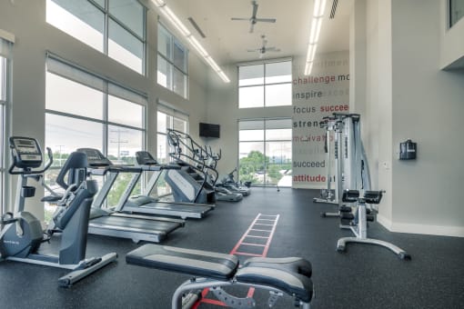 a gym with treadmills and other exercise equipment at Republic at Alamo Heights, Texas, 78209