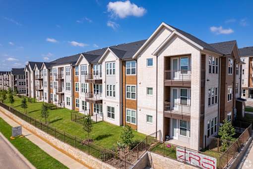 Apartment building with a fence at Kessler, Fort Worth, TX, 76137