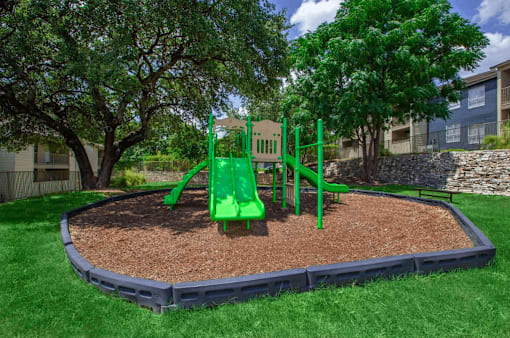 A green playground in a residential area.