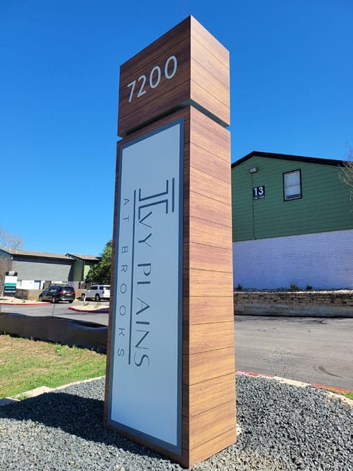 a monument with a clock on the side of a street at Ivy Plains at Brooks Apartments, San Antonio , Texas