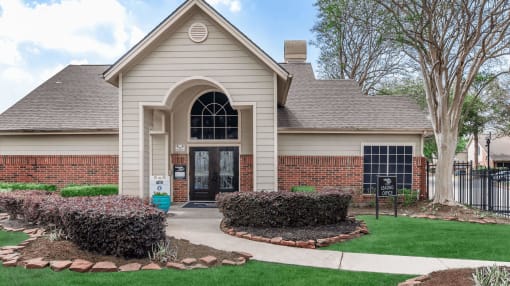 the front of a house with a driveway and lawn at Tranquility Grove, Houston