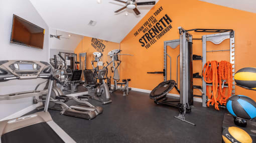 a home gym with exercise equipment and a ceiling fan at Tranquility Grove, Houston, TX 77090