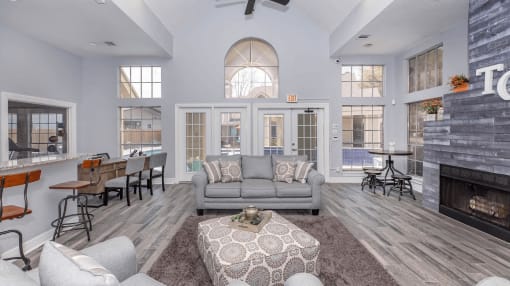 a living room with a couch and a table and a fireplace at Tranquility Grove, Houston, TX