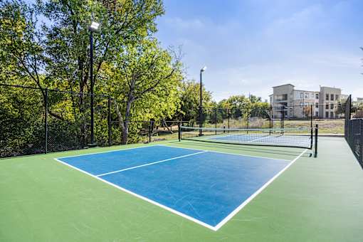 the preserve at ballantyne commons tennis court with apartments in the background at Radius on Grove, Austin