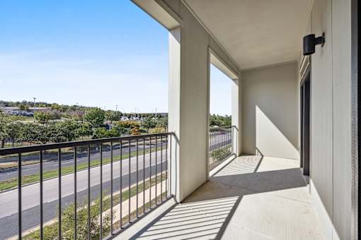 the view from the balcony of a condo with a balcony railing and a street at Radius on Grove, Texas