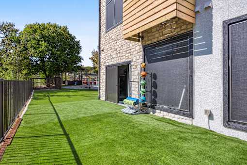 the backyard of a house with a yard and a traffic light at Radius on Grove, Austin, 78741