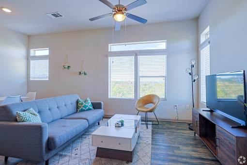 Living room with grey couchat Radius on Grove, TX, 78741