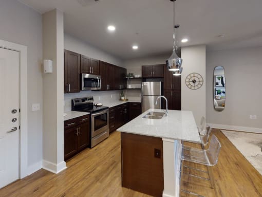 a kitchen with a marble counter top at The Fitzroy San Marcos, San Marcos