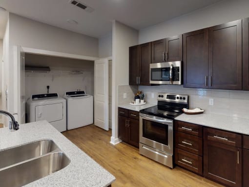 a kitchen with a stove and a sink at The Fitzroy San Marcos, San Marcos