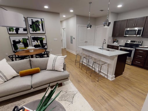 a living room with a kitchen and a couch at The Fitzroy San Marcos, San Marcos