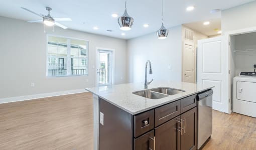 a kitchen with a sink and a counter top at The Fitzroy San Marcos, Texas