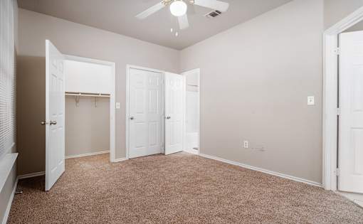 Spacious bedroom with walk-in closet at Houston Street Townhomes Apartments, Texas, 78220