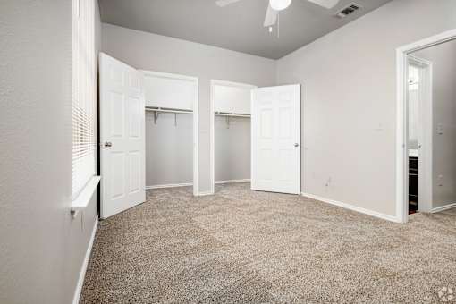 Spacious bedroom with dual walk-in closets at Houston Street Townhomes Apartments, San Antonio, 78220