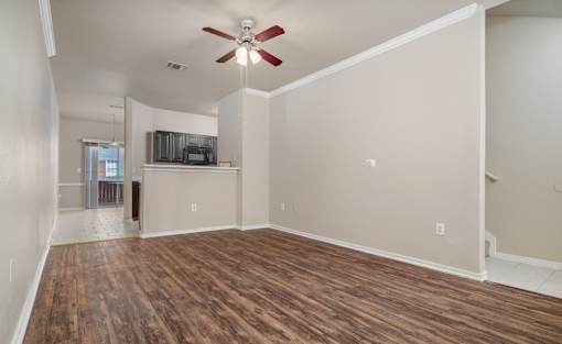Open living area with wood style flooring at Houston Street Townhomes Apartments, Texas