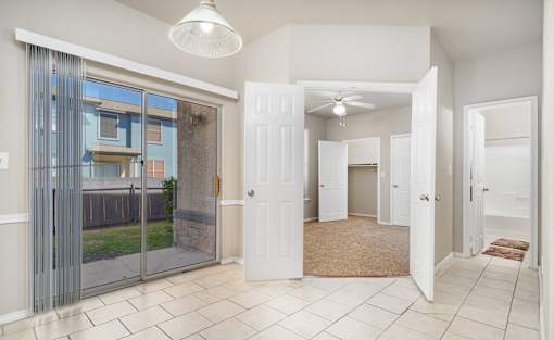 Entryway with tile flooring and patio access at Houston Street Townhomes Apartments, San Antonio